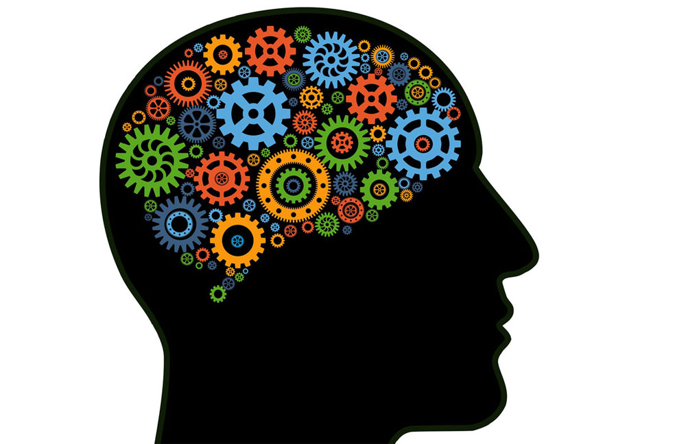 profile of a human head with many multi colored gears turning inside