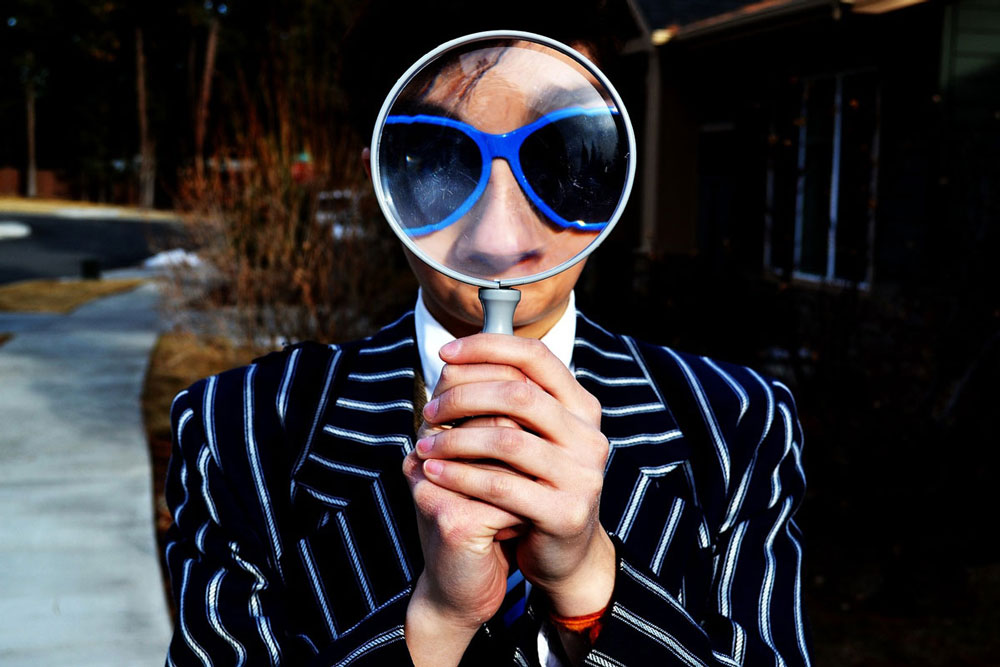 person looking through a magnifying glass