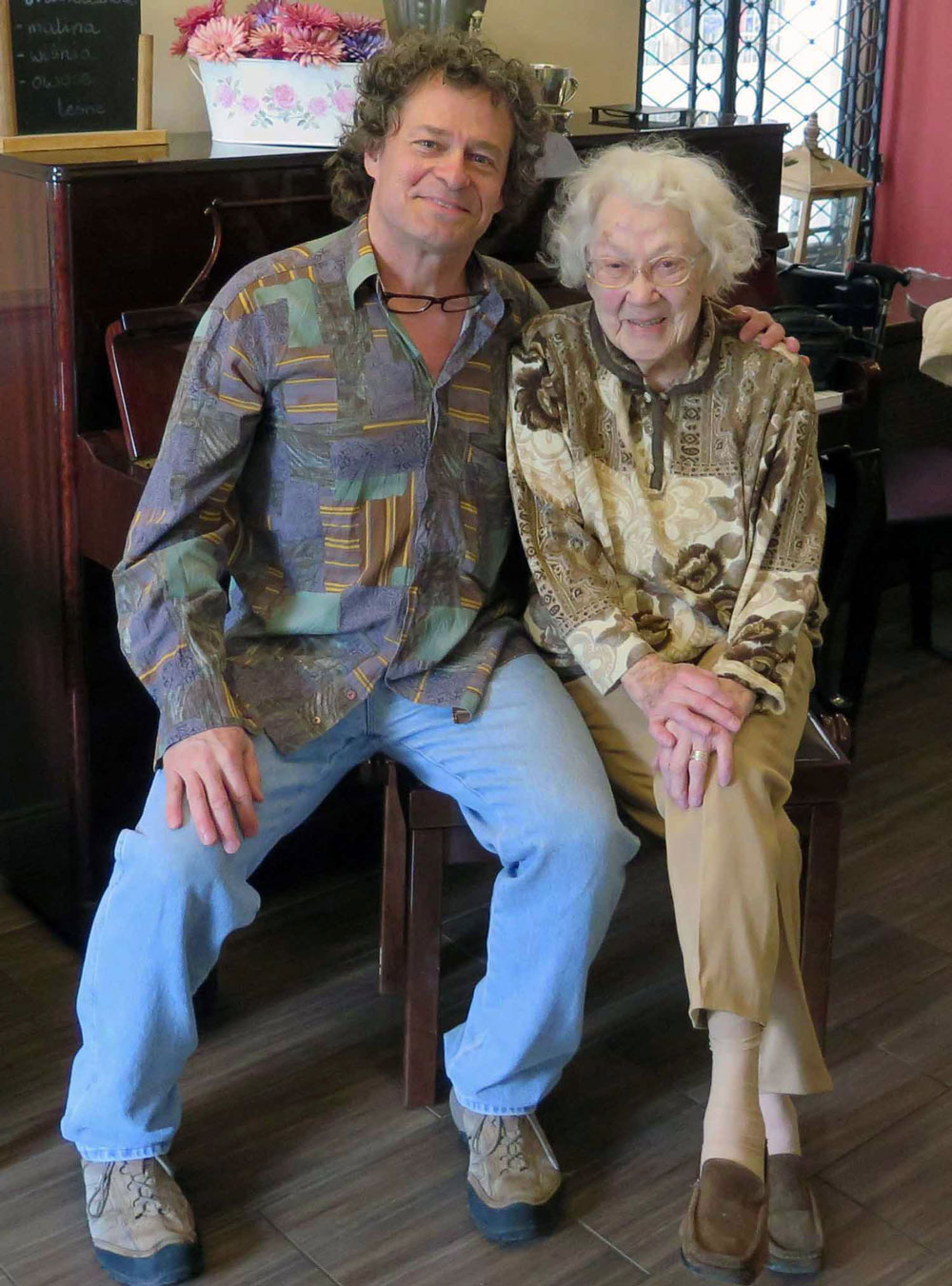 Frank Peter sitting at the piano with a lovely lady named Wistawa